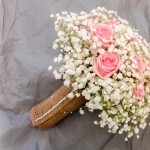 Brides Hand Tie Pink Roses and Gypsophilia