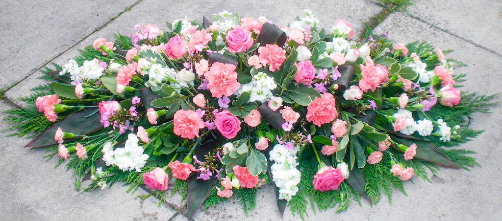 White Coffin Arrangement With Pink Roses And Pink Carnations